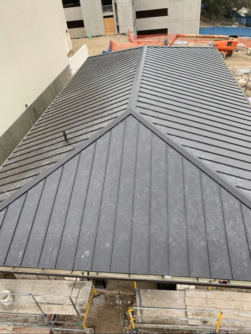 Commercial metal roof construction with crane equipment in High Springs