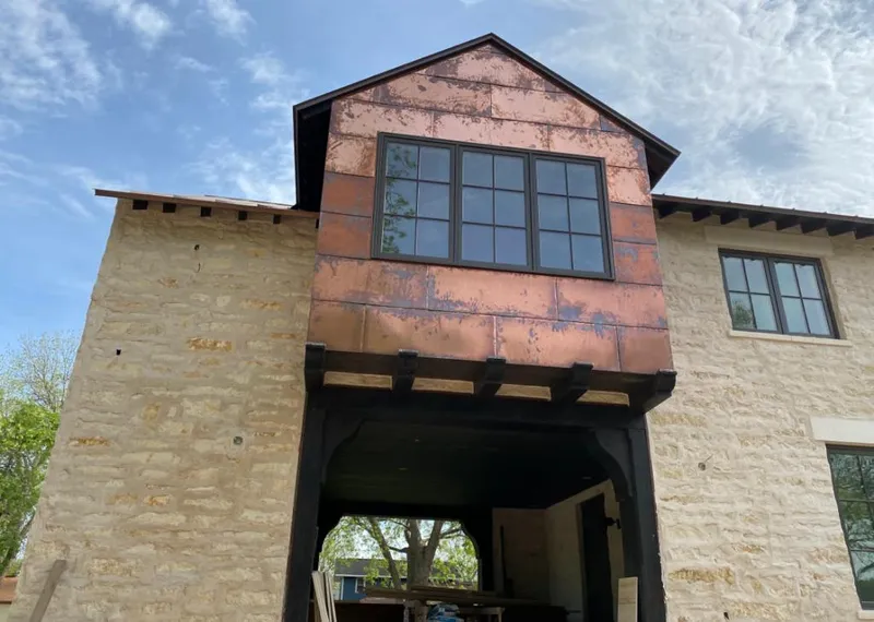 Copper metal panel facade on a stone building for Skylight Installation in High Springs